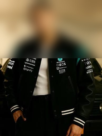 Black motorsport-inspired jacket, face hidden